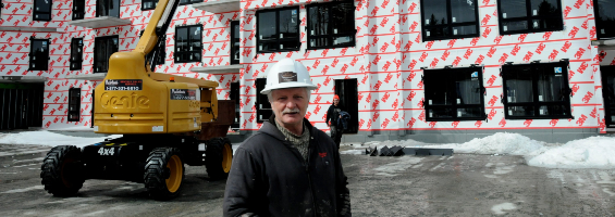 Image of Birkshire Developments founder Mike Young in front of a building where a 3M air barrier membrane has been applied