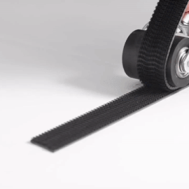 Still image from a repeating GIF showing a hand using a roller to snap together a strip of 3M™ Dual Lock™