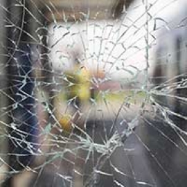 Broken glass is held in place with security film.