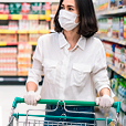 Woman Grocery shopping with mask near clean surfaces