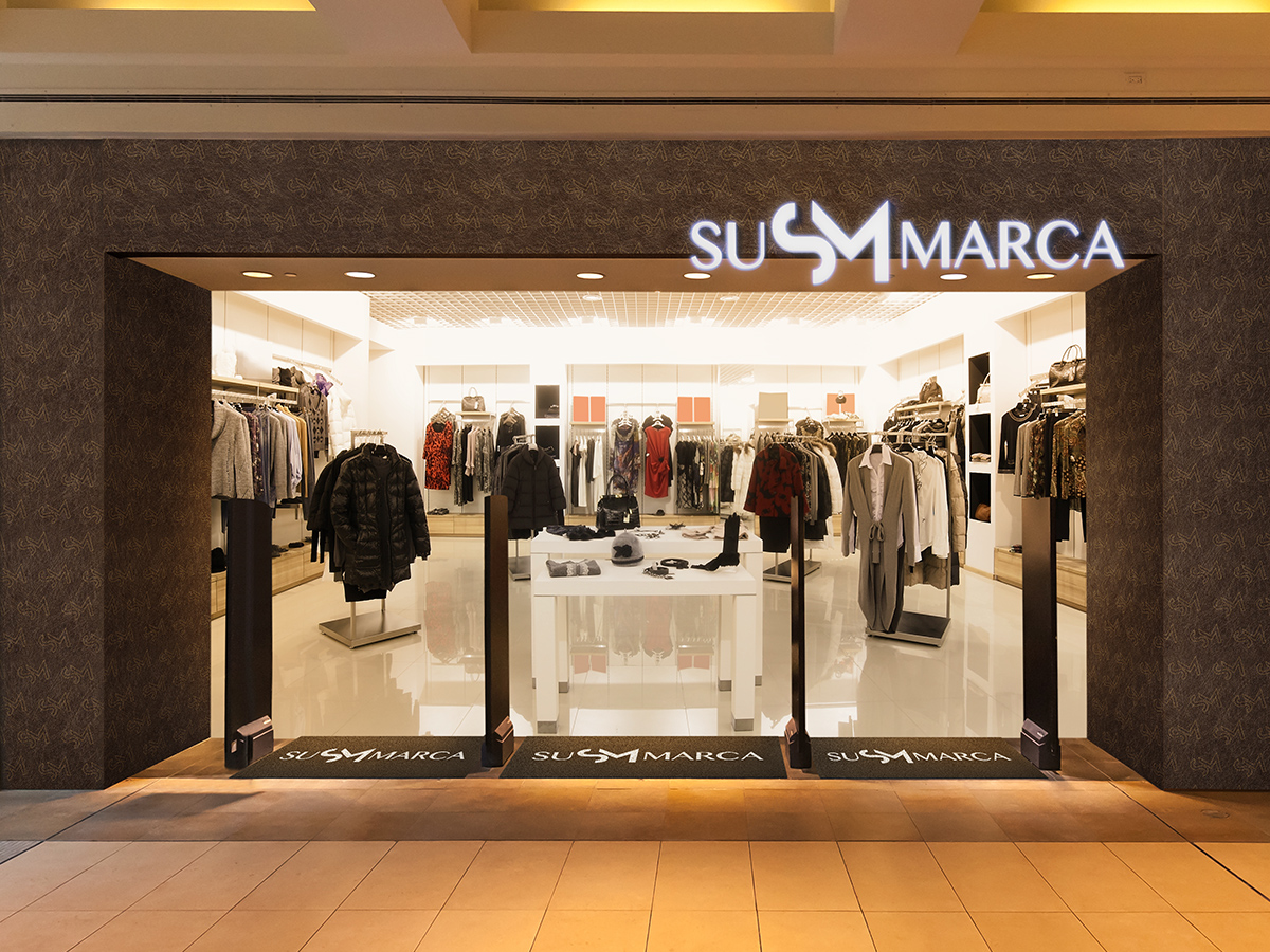 Retail clothing store with white exterior signage.
