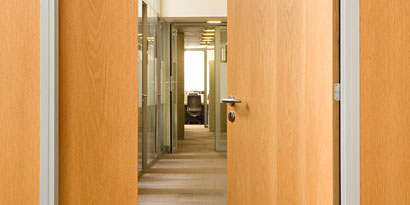 An office door and walls have 3M™ DI-NOC™ Architectural Finishes in wood grain.
