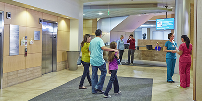 happy family walking through health care facility
