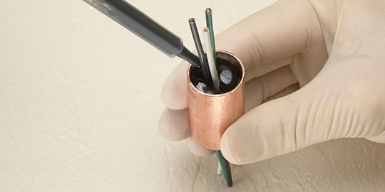 Adhesive flows over and around a component
