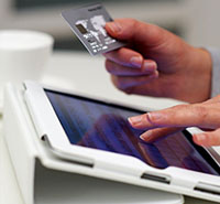 cashier using tablet to process electronic payments