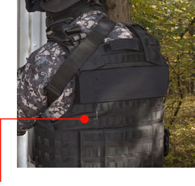 Image of a figure in camouflage clothing under an equipment vest