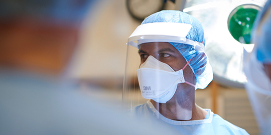 Surgeon wearing personal protective equipment
