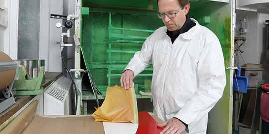 Product application image of a man putting 3M masking tape on a vehicle.
