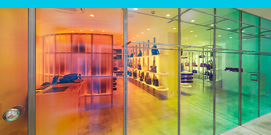 An accessories retail shop with colorful clear window wraps on the storefront.

