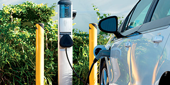 Electric vehicle plugged into an EV charging station.
