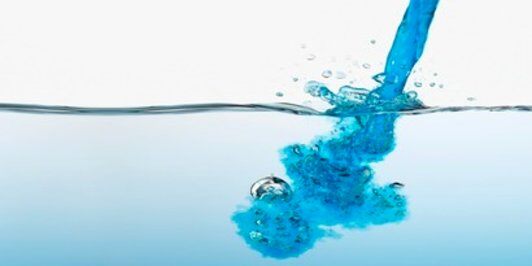 blue 3M chemical being poured into a water source to disinfect surfaces