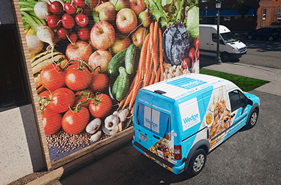 Grocery exterior wall and van with promotional graphics