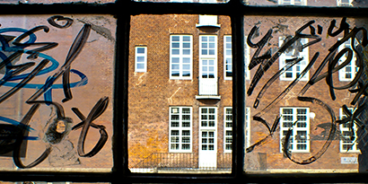 Glass is painted over with graffiti.
