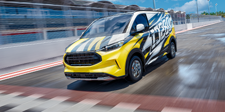 A panel van streaking across the finish line wrapped in a vibrant graphic film.
