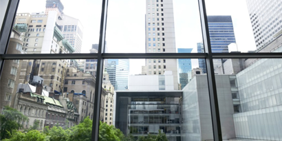 view looking up to a city landscape from inside a building
