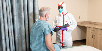 A health care provider using respiratory protection with a patient
