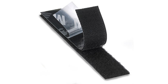 Image of a partly separated strip of 3M™ Hook and Loop with the adhesive liner partly peeled back
