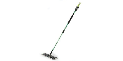 A uniformed health care worker cleans with the Easy Clean Disposable Floor Mop Pad in a commercial building.
