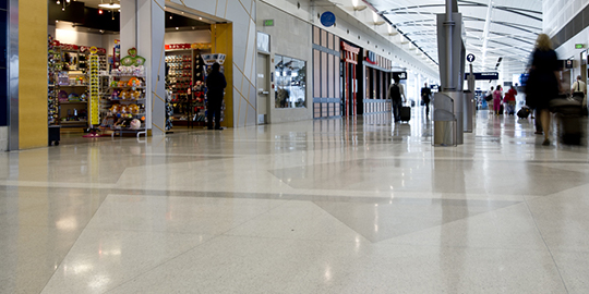 Interior of shopping mall with clean, shiny floors.
