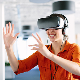 a woman using an AR/VR (augmented reality/virtual reality) headset.
