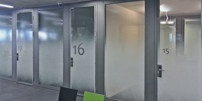 frosted glass doors on corporate meeting rooms to provide employee privacy
