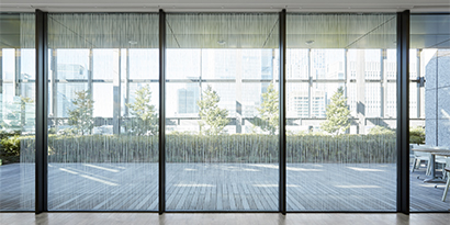 Light filters through windows in an office with window finishes.
